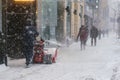 Man pushing snow with a mini snow plow on Sainte-Catherine Street