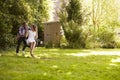 Man Pushing Woman On Tire Swing In Garden Royalty Free Stock Photo