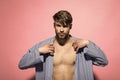 Man put blue dressing gown on pink background Royalty Free Stock Photo