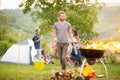 Man put firewood in flared up grill