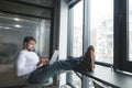 A man put his feet on the table while working on a laptop. Boss put his feet on the table while working on a computer Royalty Free Stock Photo