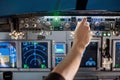 Man put his hand operate switch on airplane panel