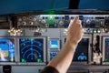 Man put his hand operate switch on airplane panel Royalty Free Stock Photo
