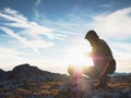 Man put the last stone intopeak of pyramid. Balanced stone pyramid on mountain summit Royalty Free Stock Photo