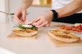 Man put slice of Italian prosciutto on top of bruschetta. Healthy home made food Royalty Free Stock Photo