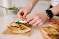 Man put slice of Italian prosciutto on top of bruschetta. Healthy home made food Royalty Free Stock Photo