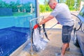 The man puts active foam on the car Mat. Car wash. Self-service washing complex. High pressure car wash Royalty Free Stock Photo