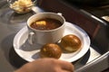 man puts borsch with donuts on his tray