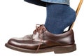 Man puts on brown shoes using shoe horn isolated Royalty Free Stock Photo