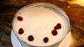 A man puts cherry filling on biscuit cakes smeared with cream. On the plate are pieces of freshly baked biscuit. Cooking Royalty Free Stock Photo