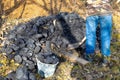 A man puts coal into a bucket with a shovel. Heating a house in the countryside Royalty Free Stock Photo