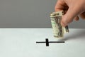 Man puts donation in his hand with dollar in slot in the form of Christian cross. Copy space for text Royalty Free Stock Photo