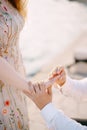 Man puts the engagement ring on the woman finger. Close-up Royalty Free Stock Photo