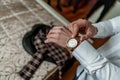 A man puts on a gold watch close up Royalty Free Stock Photo