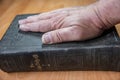 Man puts hand on the Bible
