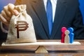 Man puts philippine peso money bag on scales with a family. Help aid migrants. Social assistance, financial support for who in Royalty Free Stock Photo