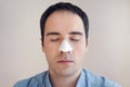 man puts on and removes strip for the nose from black dots. Coal cleaning strips from blackheads and comedones. concept