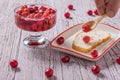 A man puts a spoon cherry jam on bread. Royalty Free Stock Photo