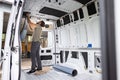 Man puts thermal insulation on the inside of a van