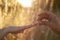 A man puts a wedding ring on a woman`s hand. Royalty Free Stock Photo