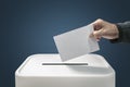 Man putting a ballot paper into a voting box concept for election, freedom and democracy Royalty Free Stock Photo