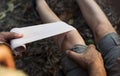 Man putting bandage on his partner`s knee in the jungle Royalty Free Stock Photo