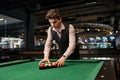 Man putting billiard balls in triangle rack Royalty Free Stock Photo