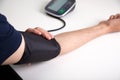 Man putting on a blood pressure monitor at home Royalty Free Stock Photo