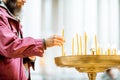 Man putting candles in the church Royalty Free Stock Photo