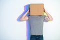 Male hiding face inside pasteboard box