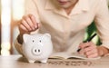 Man putting coin money into piggy bank,finance and banking, fund growth and savings concept, saving money for the future, Royalty Free Stock Photo