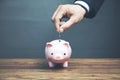 Man putting coin in piggy bank. Saving money concept Royalty Free Stock Photo