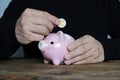 Man putting coin in piggy bank. Saving money concept Royalty Free Stock Photo