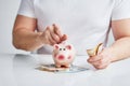 Man putting coin into piggy bank Royalty Free Stock Photo