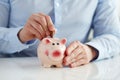 Man putting coin into piggy bank Royalty Free Stock Photo