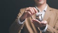 Man putting coins into a glass jar ,finance and banking, fund growth and savings concept, saving money for the future, efficient Royalty Free Stock Photo