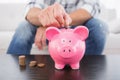 A man putting coins in piggy bank