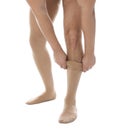 Man putting on compression stocking against background, closeup