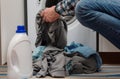 Man putting dirty clothes into washing machine Royalty Free Stock Photo