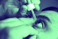 Man is putting drops in his eyes. Medical treatment concept. Allergic conjunctivitis problem