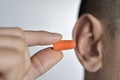 Man putting on an earplug Royalty Free Stock Photo