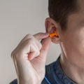 Man putting earplugs into ear Royalty Free Stock Photo