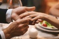 Man Putting Engagement Ring On Girfriend`s Finger After Proposal In Restaurant Royalty Free Stock Photo