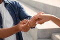 Man putting engagement ring on his girlfriend`s finger outdoors, closeup Royalty Free Stock Photo