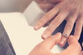 Man putting engagement ring on woman hand Royalty Free Stock Photo