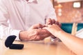 Man putting engagement ring on womans finger Royalty Free Stock Photo