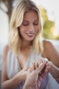 Man putting engagement ring on womans hand Royalty Free Stock Photo