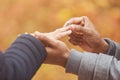 Man putting engagement silver ring on woman hand Royalty Free Stock Photo