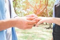 Man putting engagement silver ring on woman hand, outdoor Royalty Free Stock Photo