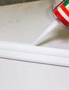 Man is putting glue on gypsum baseboard. Maintenance repair works renovation in the flat . Restoration indoors. Drywall panel Royalty Free Stock Photo